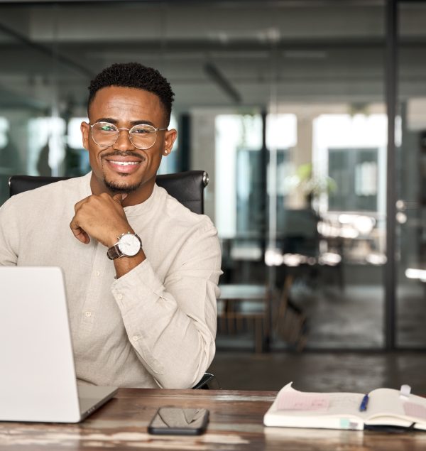 A business professional working with a laptop in a modern office.